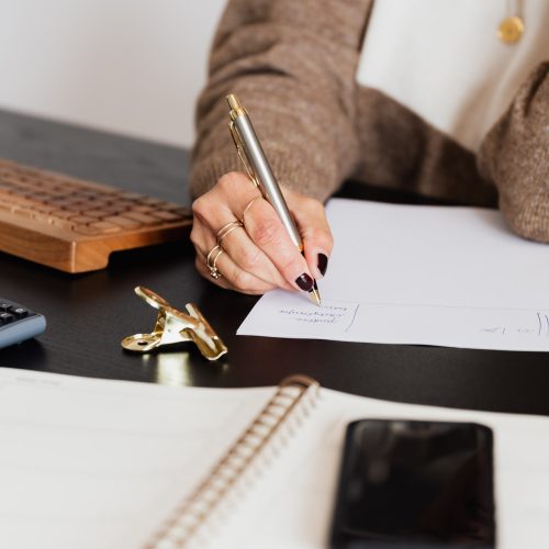 crop-elegant-business-lady-taking-notes-while-sitting-at-4491492.jpg
